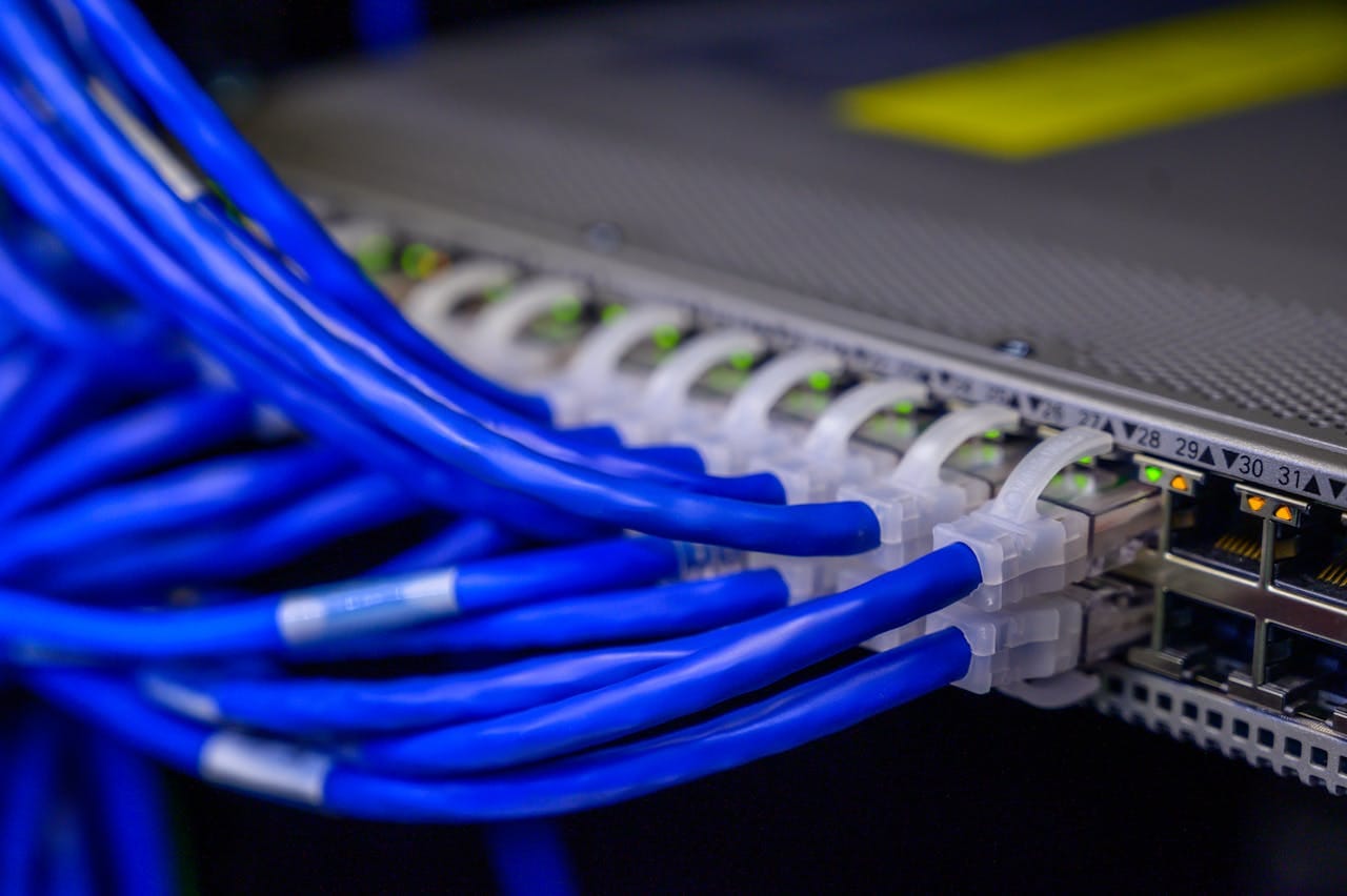 About Detailed view of blue ethernet cables connected to a network switch in a data center.